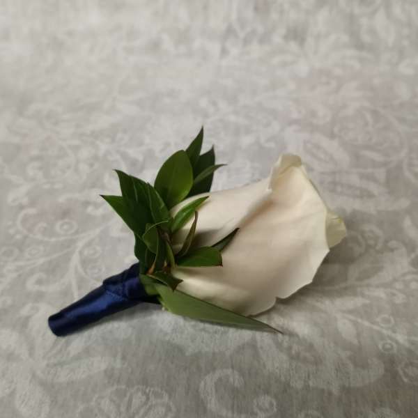White rose boutonniere with dark blue ribbon wrap
