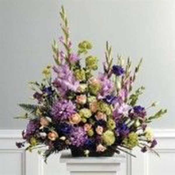 Tall mixed bouquet with purple, peach, and green flowers