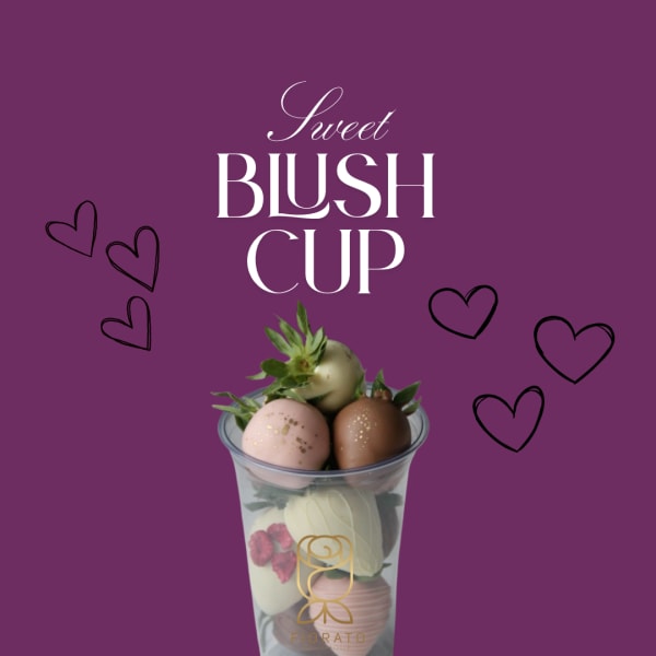 Chocolate-dipped strawberries in a clear cup with decorative hearts