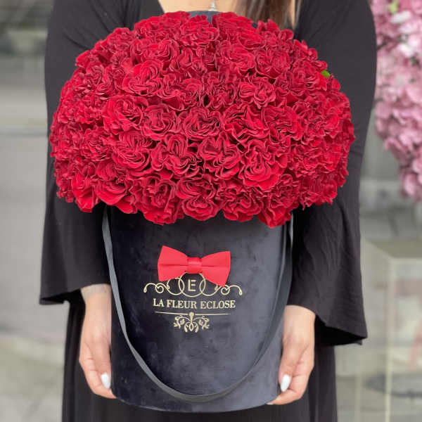 Large red rose bouquet in a black hatbox with a red bow