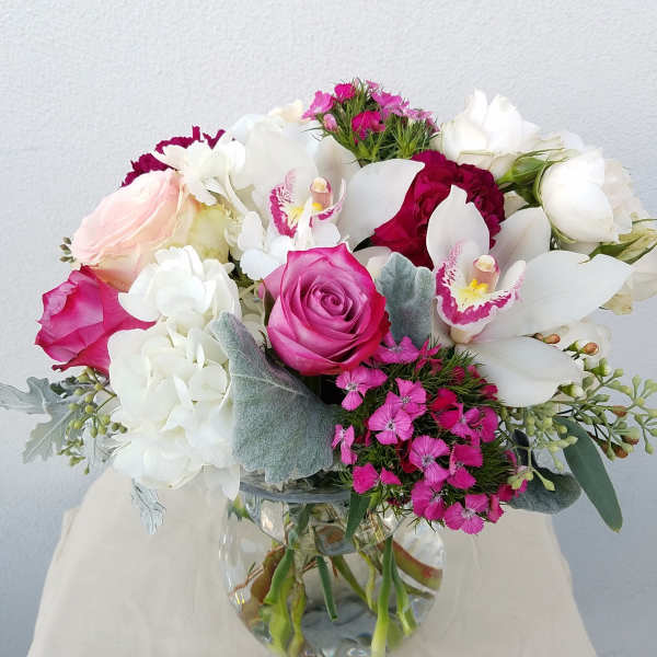 Pink and white bouquet in a clear glass vase