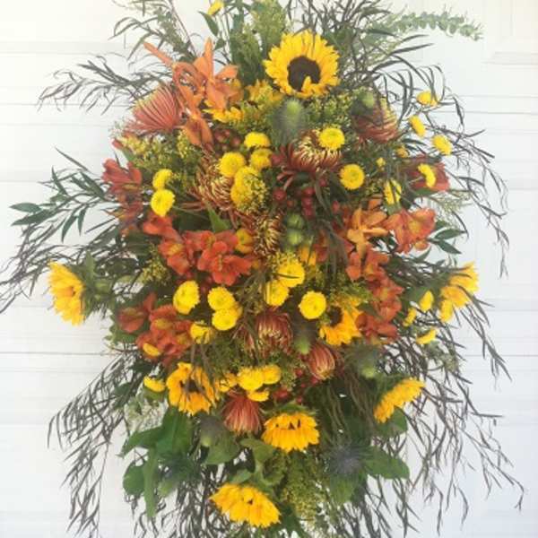 Tall standing floral spray with yellow and orange flowers