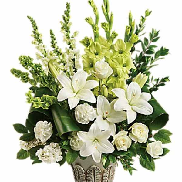 White lilies and roses in a decorative vase with green flowers