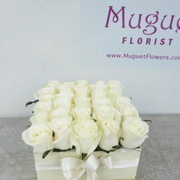 White rose arrangement in a square box with a ribbon