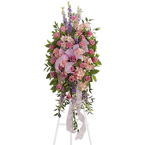 Tall pink and lavender floral spray on a white easel