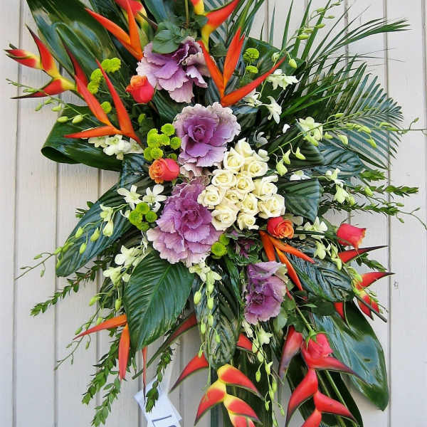 Tropical standing spray with red heliconia, purple cabbage roses, and white roses