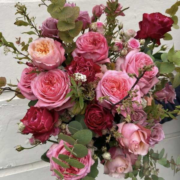 Bouquet of pink and red roses with eucalyptus