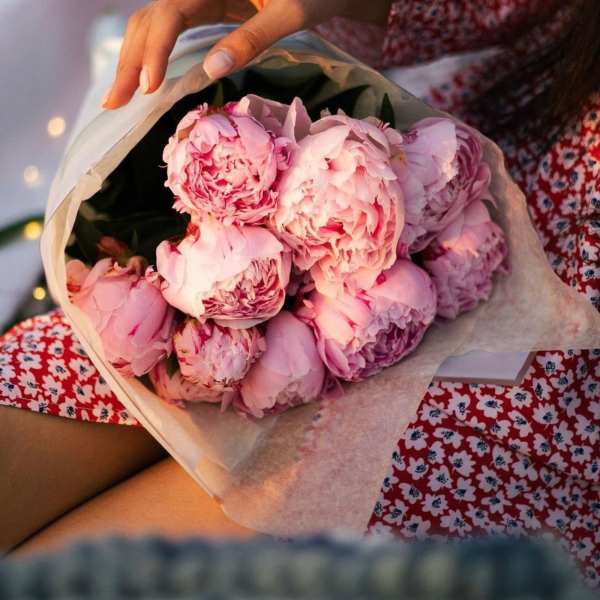 Bouquet of pink peonies wrapped in paper