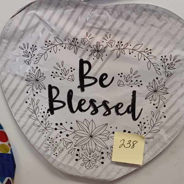 Heart-shaped silver balloon with 'Be Blessed' text and black floral outlines.