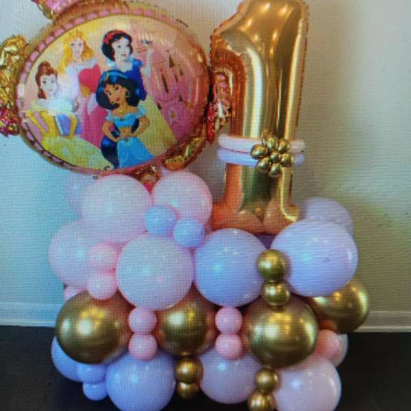 Princess-themed balloon display with a gold number 1 and pastel balloons