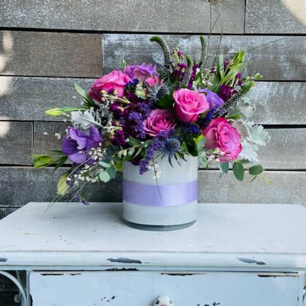 Bouquet of pink and purple flowers in a white vase