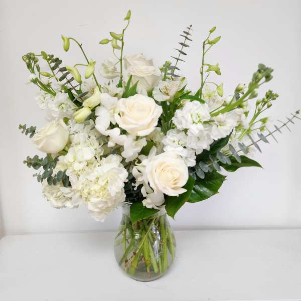 White floral arrangement in a clear glass vase
