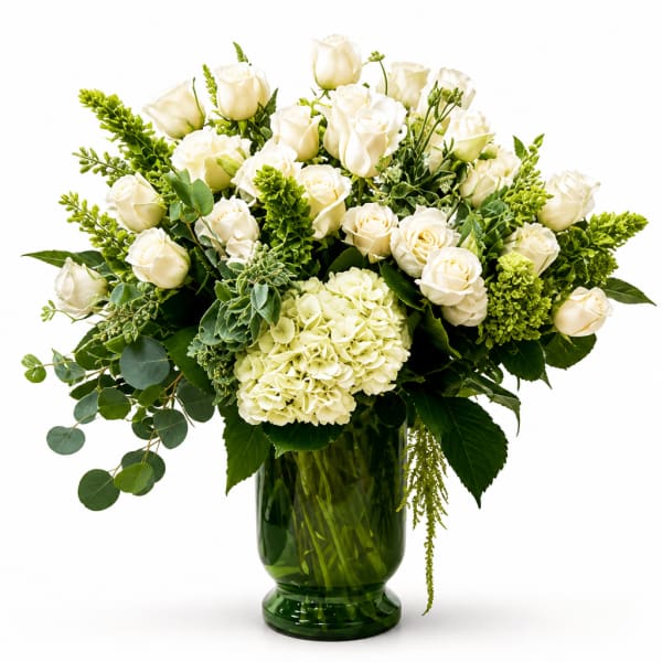 White roses and hydrangea in a green glass vase