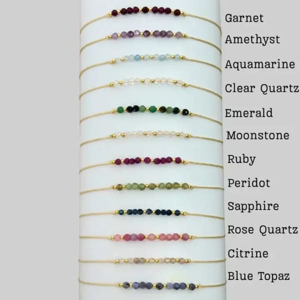Beaded gemstone bracelets displayed on a white card with stone names.