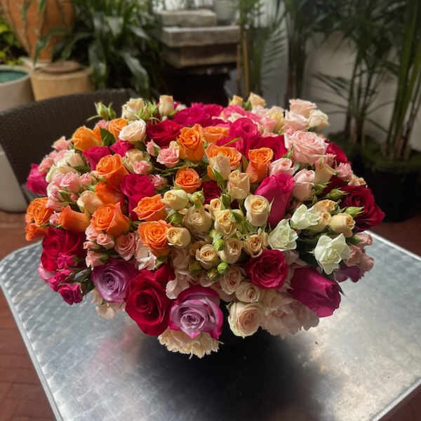 Large bouquet of multicolored roses on a table