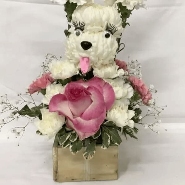 White floral teddy bear arrangement with pink accents on a box base