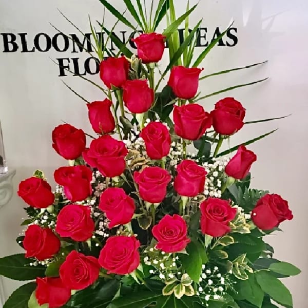 Tall bouquet of red roses with baby's breath and greenery