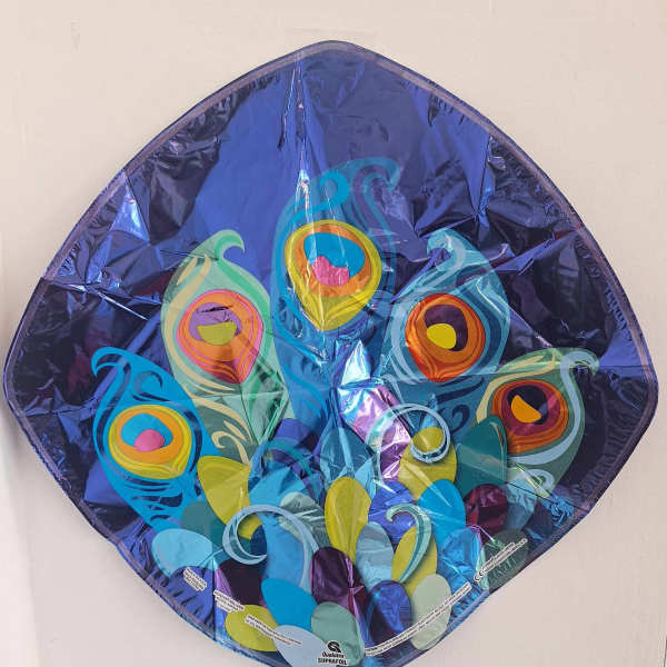 Peacock-shaped foil balloon with colorful feather patterns
