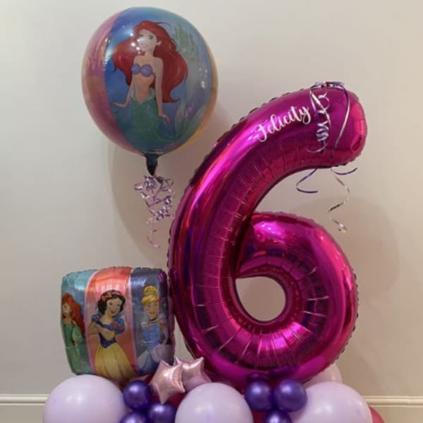 Princess-themed balloon arrangement with a large pink number 6 balloon