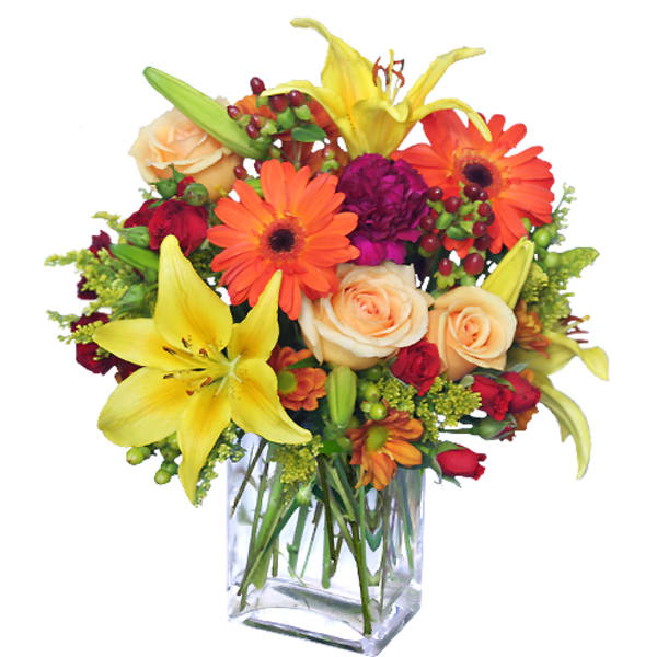 Bright mixed bouquet with lilies, roses, and orange daisies in a clear glass vase
