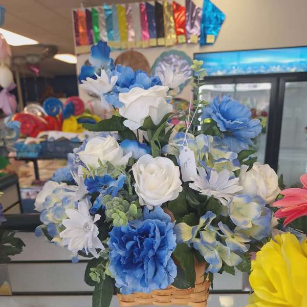 Basket arrangement of blue and white artificial flowers