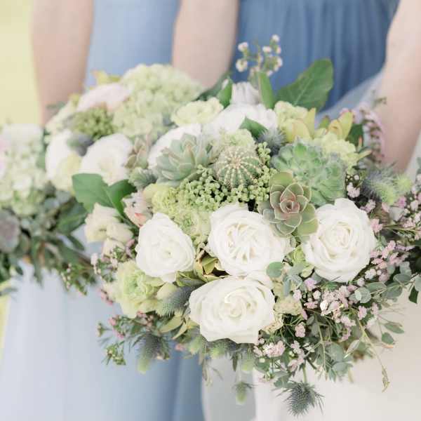 White rose and succulent bouquet with soft pink accents
