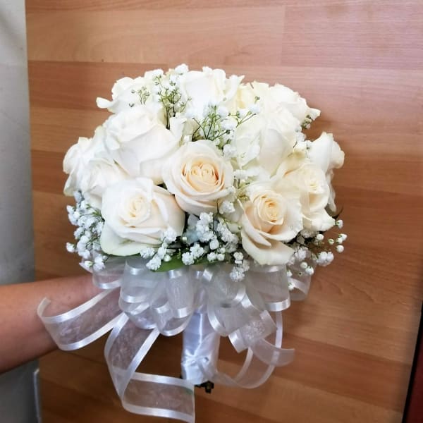 White rose bouquet with baby's breath and a white ribbon bow