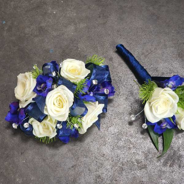 White roses with blue ribbon and accents, plus a matching boutonniere