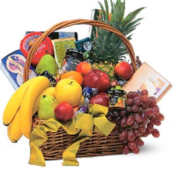 Fruit basket with bananas, grapes, apples, pineapple, and packaged snacks