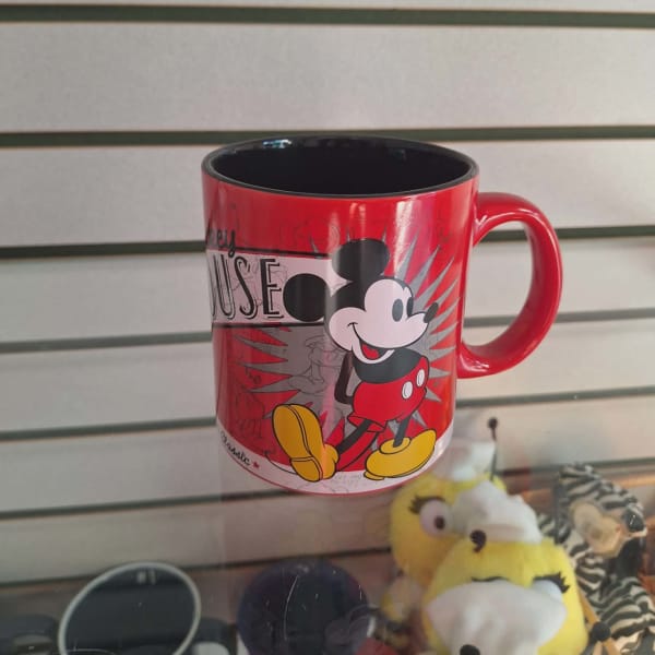 Red Mickey Mouse mug with a black interior on a shelf