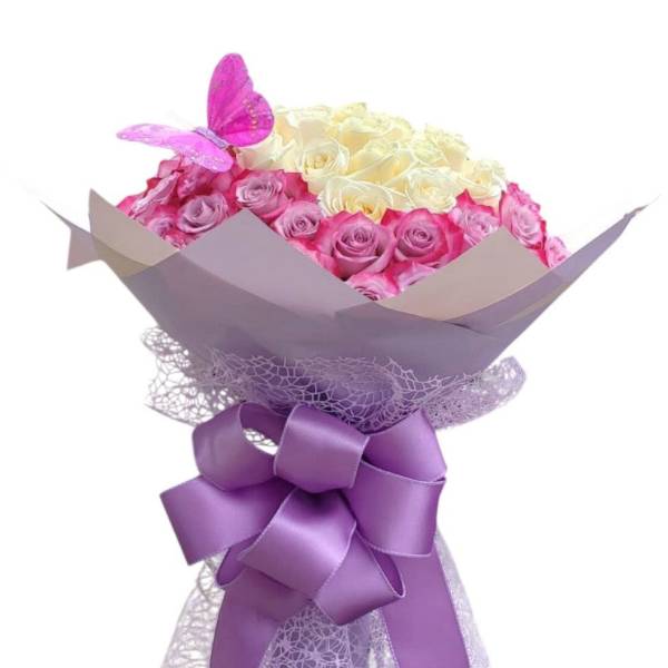 Bouquet of pink and cream roses with a purple butterfly and ribbon wrap