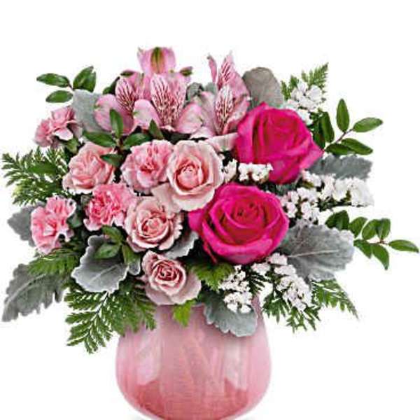 Pink roses and alstroemeria in a pink glass vase