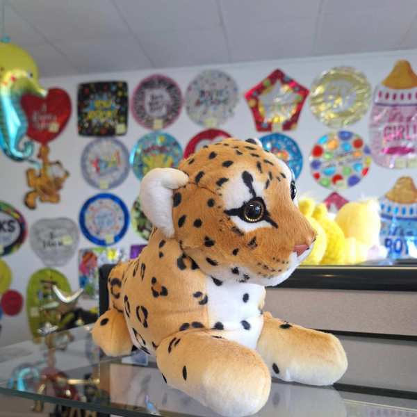 Plush spotted big cat toy on a counter
