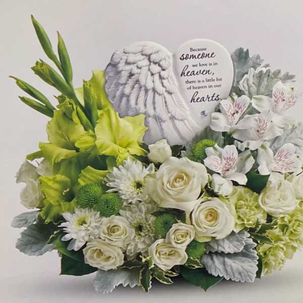 White and green sympathy arrangement with roses and a memorial plaque