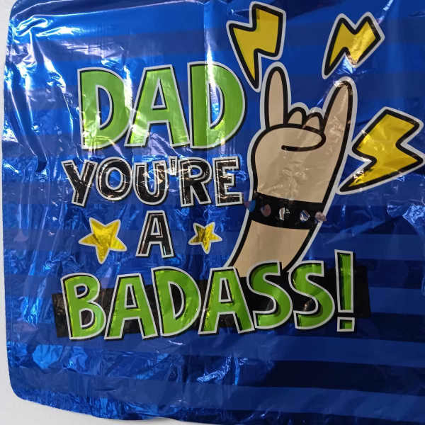 Blue foil balloon with "Dad you're a badass" text and hand gesture graphic