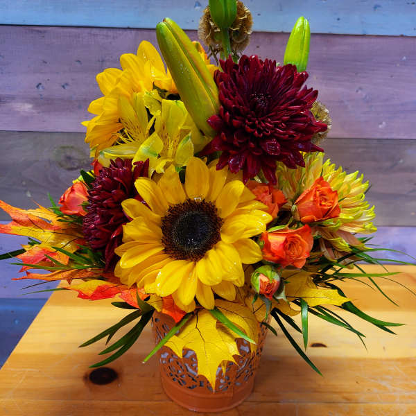 Sunflower and chrysanthemum arrangement in a decorative metal container