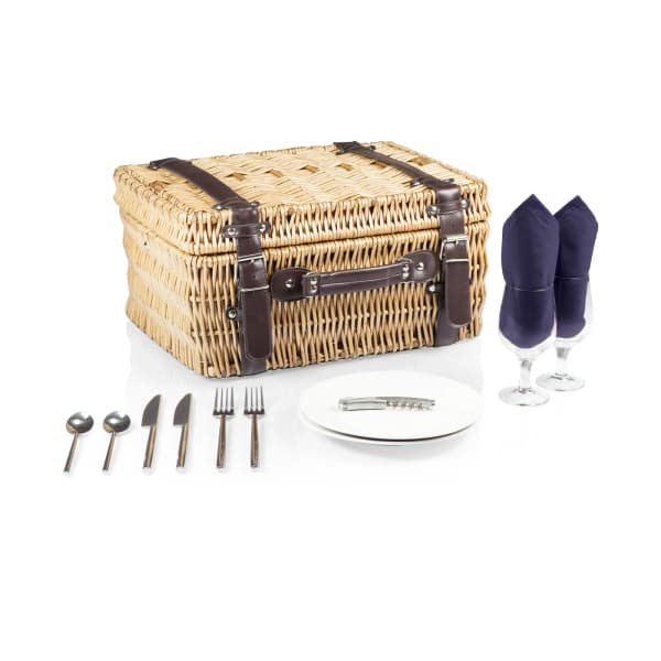 Picnic basket with plates, utensils, and two wine glasses with napkins