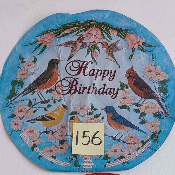 Round blue birthday balloon with birds and pink blossoms