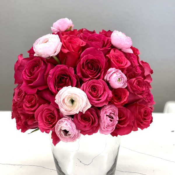 Pink and red rose bouquet in a clear glass vase