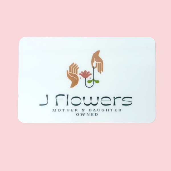 White business card with a flower logo on a pink background