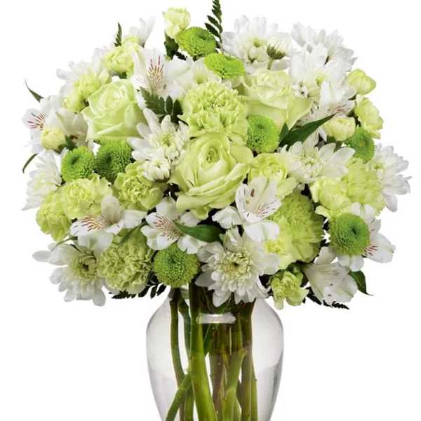 Green and white bouquet in a clear glass vase