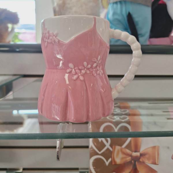 Pink ceramic mug with a floral dress shape and white handle