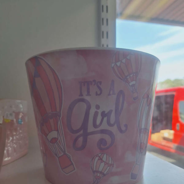 Pink pot with hot air balloons and the words "It's A Girl"