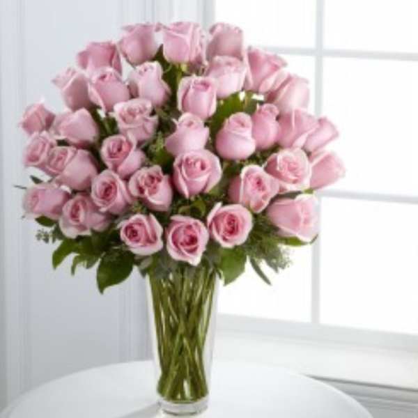Pink roses arranged in a clear glass vase