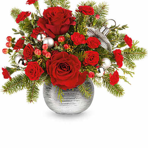 Red roses and carnations in a silver vase with holiday ornaments
