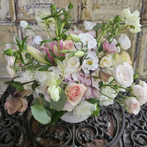 Soft pink and white mixed bouquet in a white vase