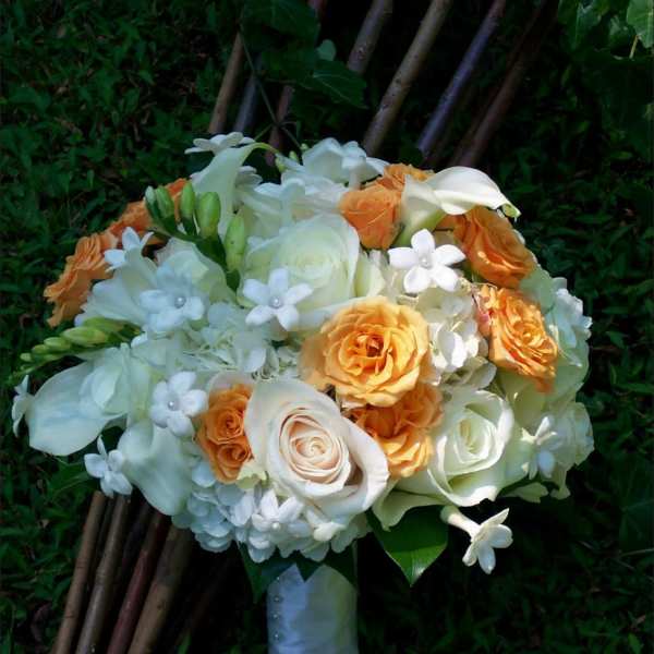 Bouquet of white and orange roses with small white flowers