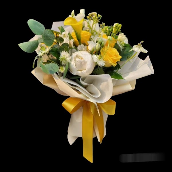 Yellow and white bouquet wrapped in cream paper with a yellow ribbon