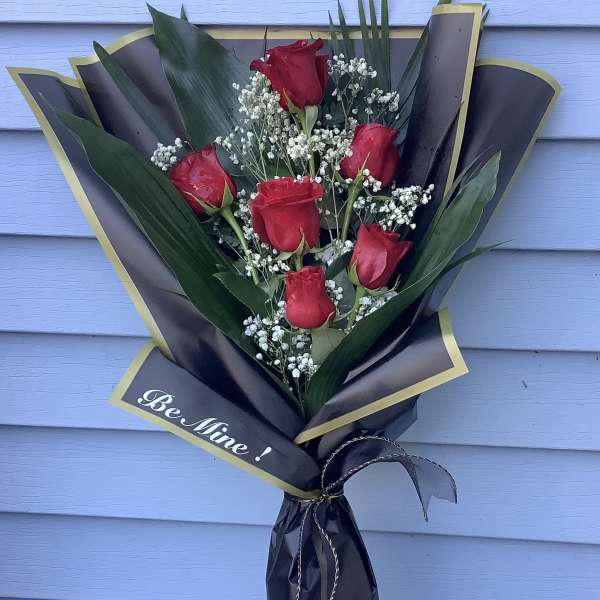 Bouquet of red roses with baby's breath in black and gold wrap