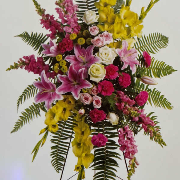 Tall standing floral spray with pink, yellow, and white flowers